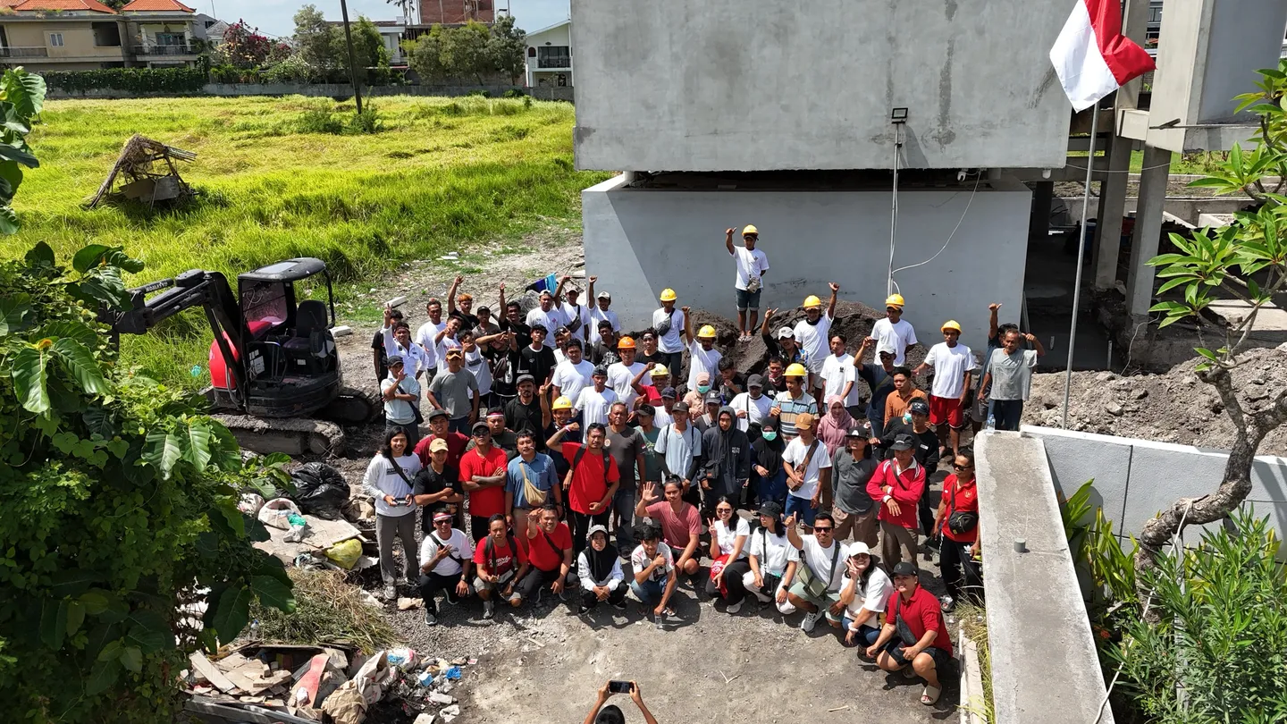 Aerial view of the Perfect 10 Construction team gathered on site, in black and white.